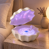 Shell Wave speaker on a bedside table, styled product visualization